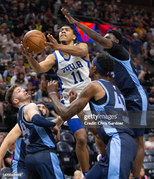 Jaden Springer of the Philadelphia 76ers drives to the basket between Tarik Biberovic, Vince Williams Jr., #5, and Tariq Owens of the Memphis...