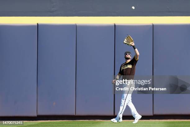 Outfielder David Dahl of the San Diego Padres catches a fly ball out during the first inning of the spring training game against the Los Angeles...