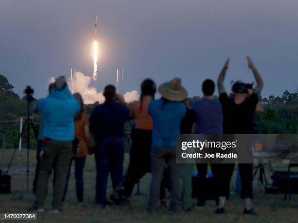 People watch as a SpaceX Falcon 9 rocket lifts off from launch pad 40 at Cape Canaveral Space Force Station on February 27, 2023 in Cape Canaveral,...