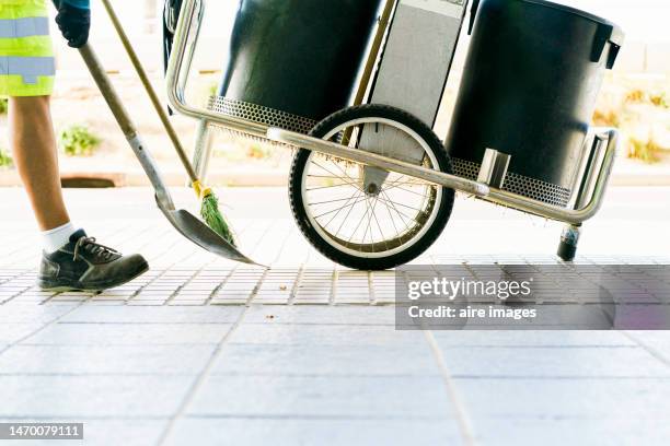 worker sweeping footpath - road sweeper stock pictures, royalty-free photos & images