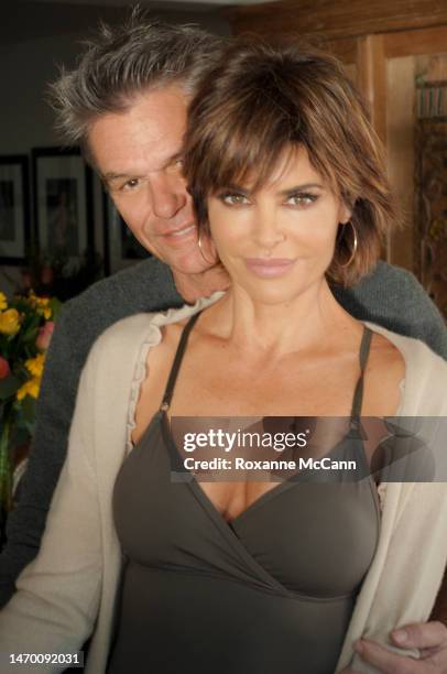 Actor Harry Hamlin and actress Lisa Rinna pose for a photo on January 7, 2013 in Malibu, California.