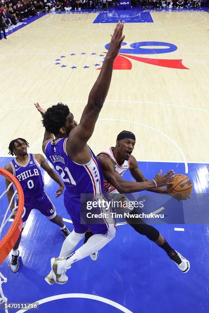 Joel Embiid of the Philadelphia 76ers guards Jimmy Butler of the Miami Heat during the third quarter at Wells Fargo Center on February 27, 2023 in...