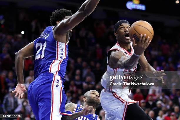 Jimmy Butler of the Miami Heat shoots a lay up past Joel Embiid of the Philadelphia 76ers during the fourth quarter at Wells Fargo Center on February...