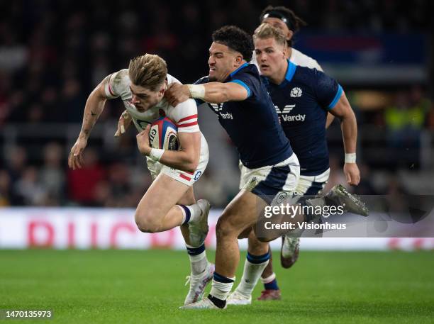 Ollie Hassell-Collins of England is tackled by Sione Tuipulotu of Scotland during the Six Nations Rugby match between England and Scotland at...