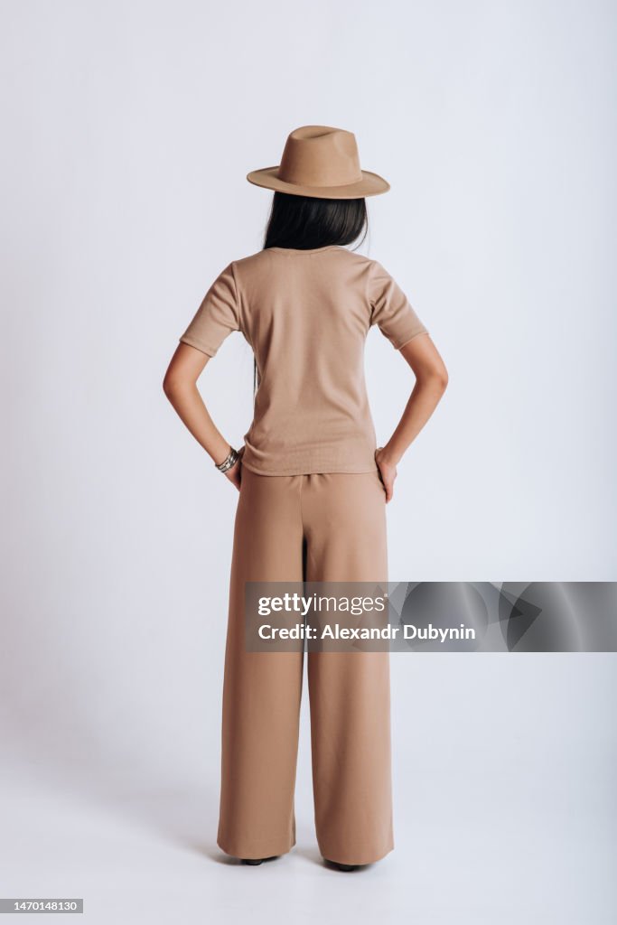 Model Back Side View Back View Of A Female Model Posing In A New Collection Of Clothes On A ...