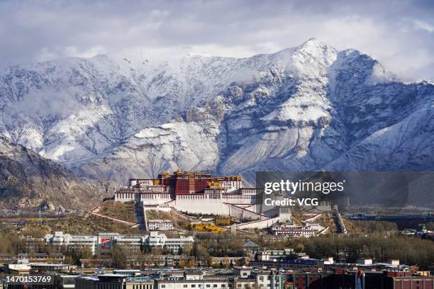 General view of the landmark Potala Palace with snow mountains in the background on February 28, 2023 in Lhasa, Tibet Autonomous Region of China.