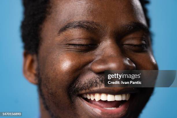 close up happy african american man with toothy smile. - extreme close up mouth stock pictures, royalty-free photos & images