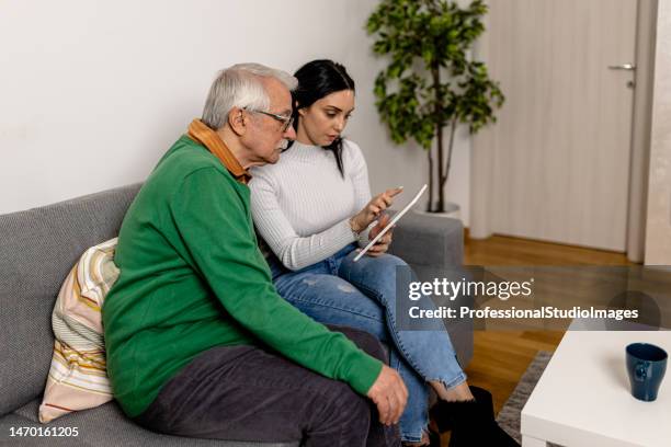 senior man learning how to use digital tablet - hands holding tablet a pair of glasses stock pictures, royalty-free photos & images