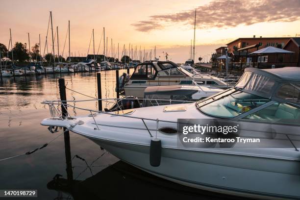 a marina at sunset. - motorboat stockfoto's en -beelden