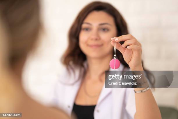 female gynecologist doctor and patient are talking about menstrual cup - girl using tampon stockfoto's en -beelden