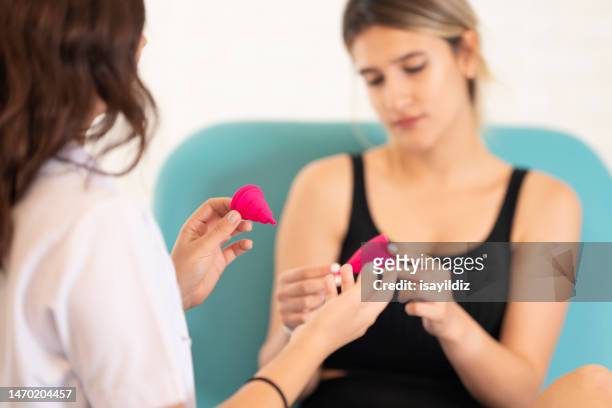 female gynecologist doctor and patient are talking about menstrual cup - girl using tampon stock pictures, royalty-free photos & images