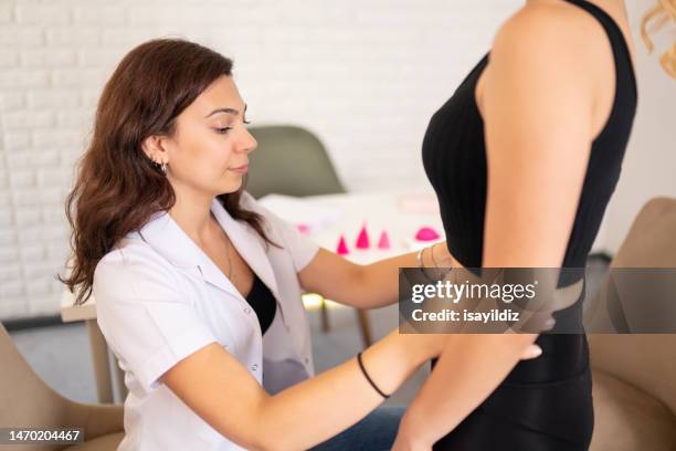 female gynecologist doctor and patient are talking about menstrual cup - girl using tampon stock pictures, royalty-free photos & images