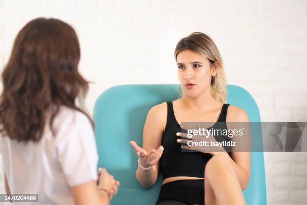 female gynecologist doctor and patient are talking about menstrual cup - girl using tampon stock pictures, royalty-free photos & images