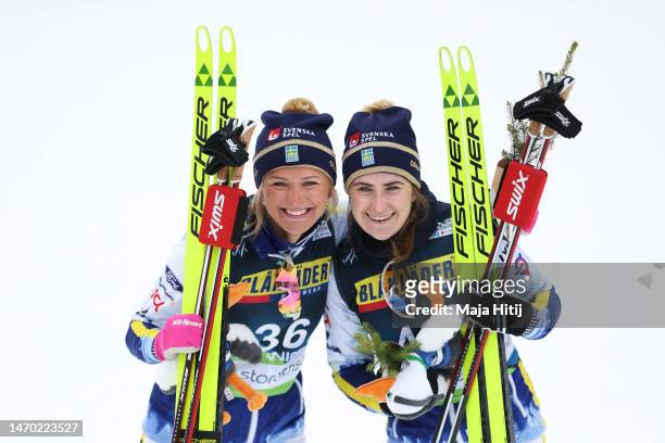 Silver medalist, Frida Karlsson of Sweden and bronze medalist, Ebba Andersson of Sweden celebrate victory following the Cross-Country Women's 10km...