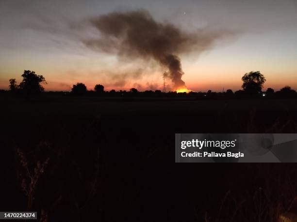 Air pollution caused by burning of crop waste, wheat straw being burnt in an open field on February 14, 2023. The massive cloud or plume of smoke...