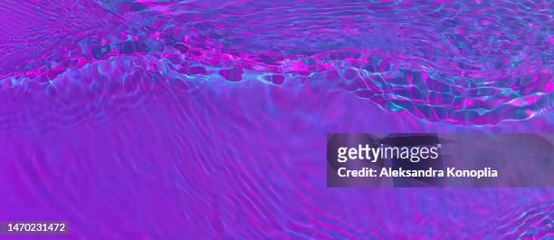 ethereal dark holographic purple, pink, blue transparent water surface texture with ripples, splashes, waves - nightclub bathroom stock pictures, royalty-free photos & images