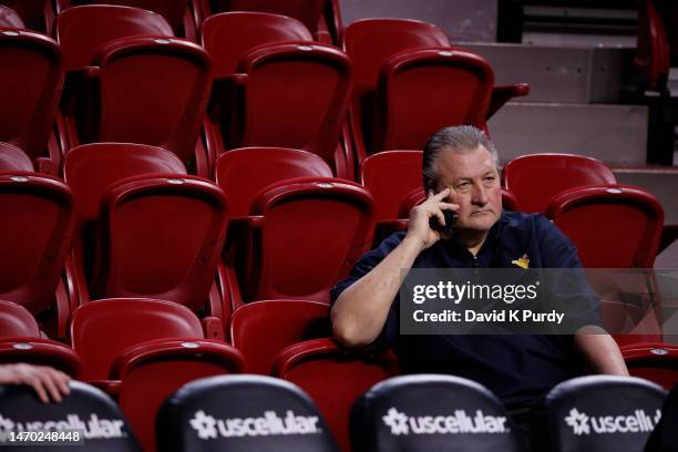 Head coach Bob Huggins of the West Virginia Mountaineers talks on the phone during pregame warmups at Hilton Coliseum on February 27, 2023 in Ames,...