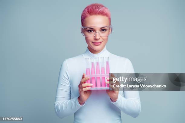 portrait of beauty scientist worker lady hold bottles with essntial liquid isolated on grey color background - lady grey background bildbanksfoton och bilder