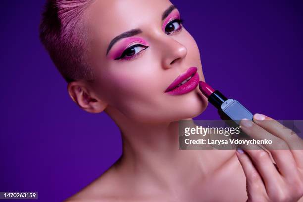 closeup photo of fashionista girl apply matte glossy resolution lipstick on plump lips smooth decorative trendy color - matte lips 個照片及圖片檔