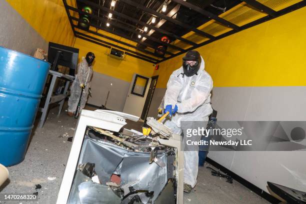 John Crino, of Mount Sinai, breaks a television at Rage Room Long Island in Selden, New York, where participants can take their rage out on ordinary...