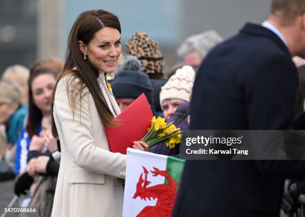 Catherine, Princess of Wales shakes hands and speaks to well-wishers as she departs Aberavon Leisure & Fitness Centre with Prince William, Prince of...