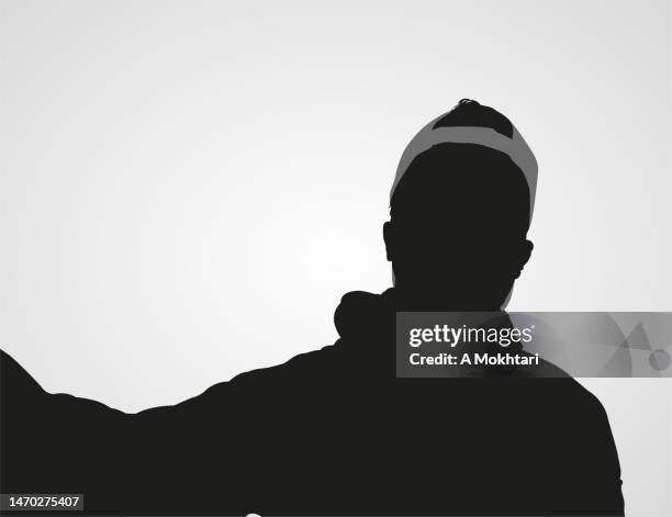 silhouette of a young man taking a selfie with a cap. - selfie stock illustrations