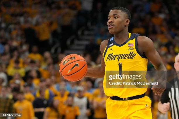 Kam Jones of the Marquette Golden Eagles dribbles the ball against the DePaul Blue Demons in the first half at Fiserv Forum on February 25, 2023 in...