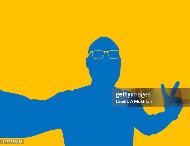 silhouette of a man taking a selfie in yellow and blue color. - duality stock illustrations