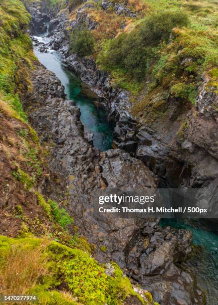 high angle view of stream flowing through rocks,western,iceland - brook mitchell stock pictures, royalty-free photos & images