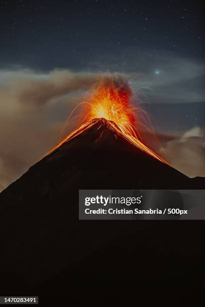 low angle view of mountain against sky at night,guatemala - volcanic activity fotografías e imágenes de stock