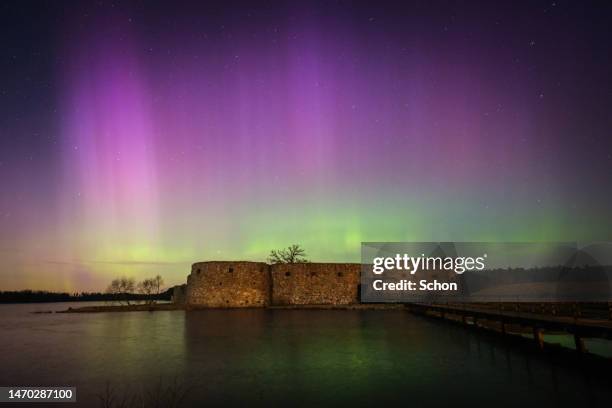 northern lights over an ancient castle ruin in winter - vaxjo stock pictures, royalty-free photos & images