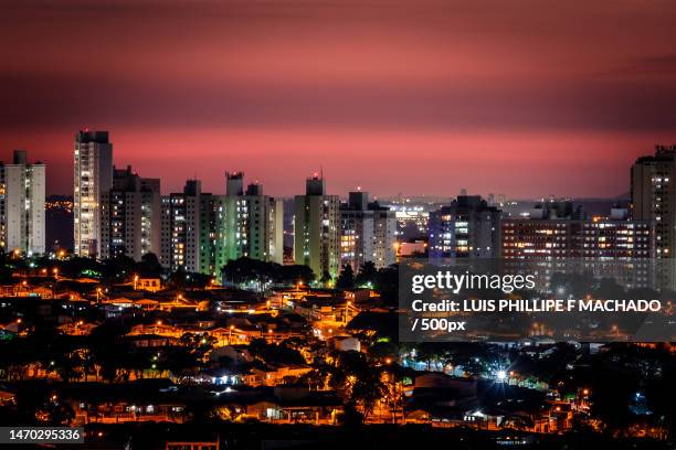 high angle view of illuminated buildings against sky at night,campinas,brazil - campinas stock-fotos und bilder