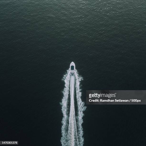 aerial view of boat in sea - speed boat stock pictures, royalty-free photos & images