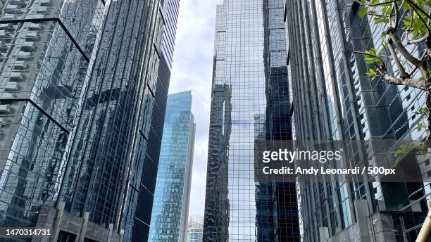 low angle view of modern buildings against sky,south jakarta,indonesia - indonesia city stock pictures, royalty-free photos & images