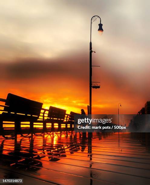 silhouette of pier over sea against sky during sunset,long beach,new york,united states,usa - long beach new york stock pictures, royalty-free photos & images