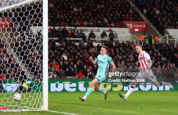 Evan Ferguson of Brighton & Hove Albion scores the team's first goal whilst under pressure from Ben Wilmot of Stoke City during the Emirates FA Cup...