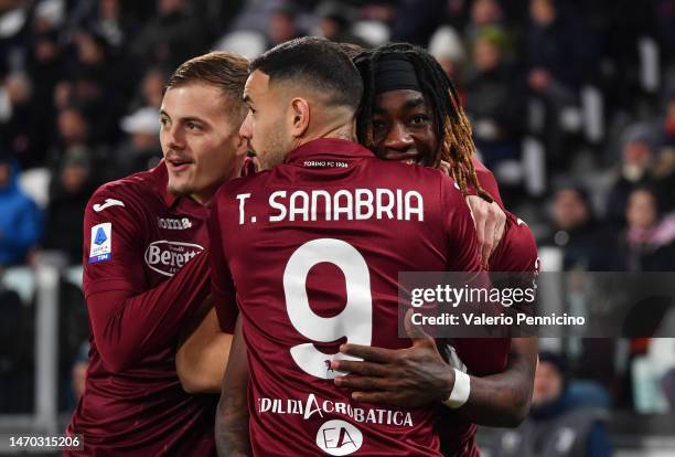 Yann Karamoh of Torino FC celebrates after scoring the team's first goal with teammates during the Serie A match between Juventus and Torino FC at...