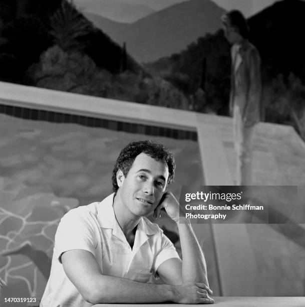 David Geffen rests his face on his hand in front of a swimming pool in Los Angeles in 1987.