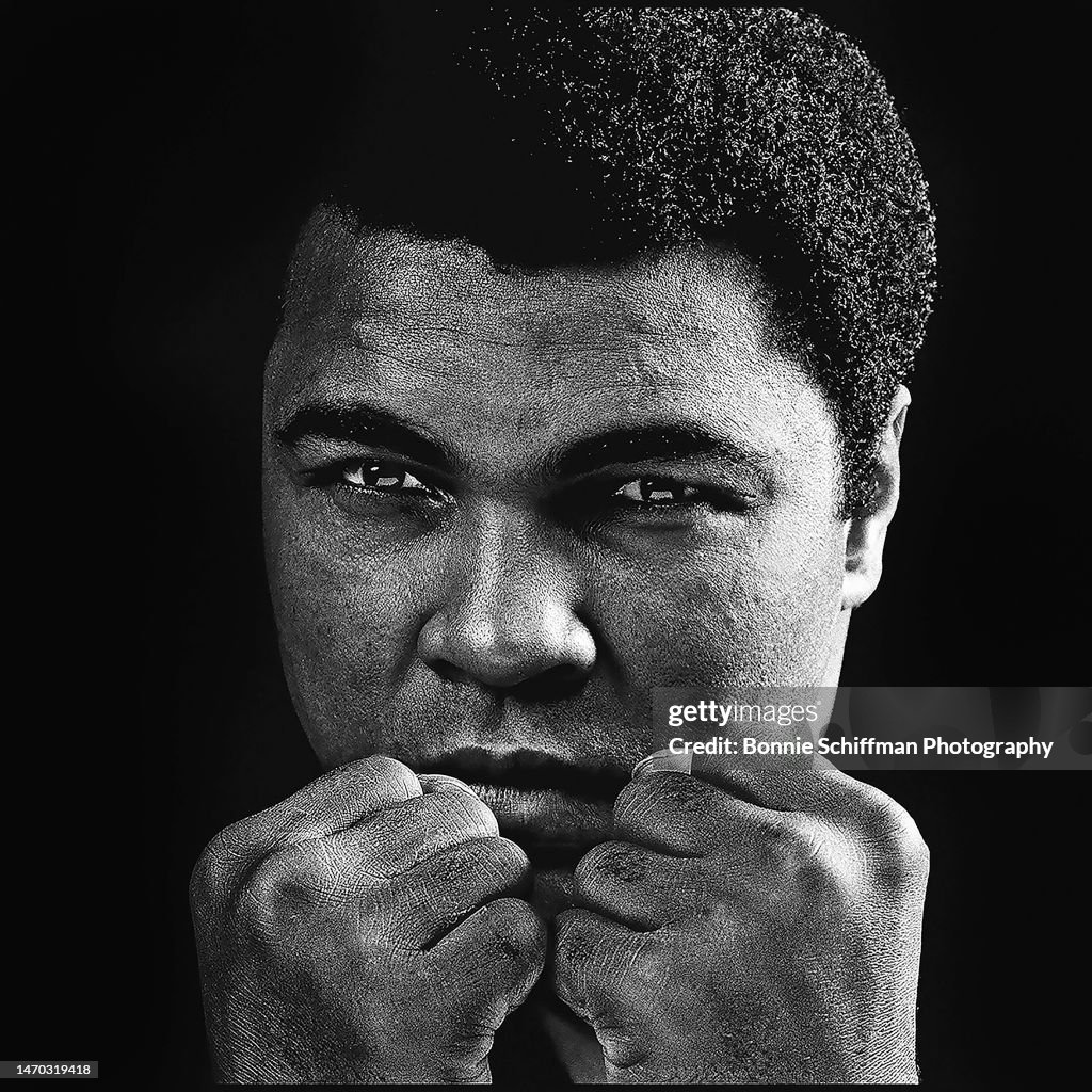 Legendary Boxer Muhammad Ali Poses With His Fists Blocking His Chin legendary-boxer-muhammad-ali-poses-with-his-fists-blocking-his-chin