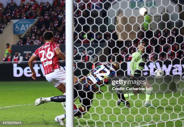 Phil Foden of Manchester City scores the team's first goal as Max O'Leary of Bristol City attempts to make a save during the Emirates FA Cup Fifth...