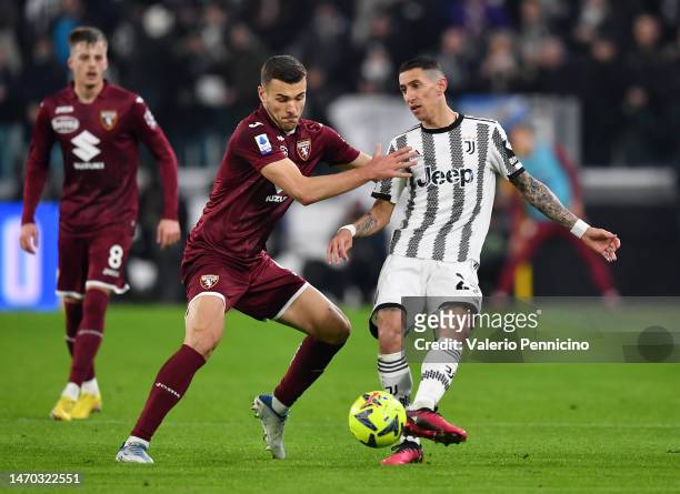 Angel Di Maria of Juventus passes the ball Alessandro Buongiorno of Torino FC during the Serie A match between Juventus and Torino FC at Allianz...
