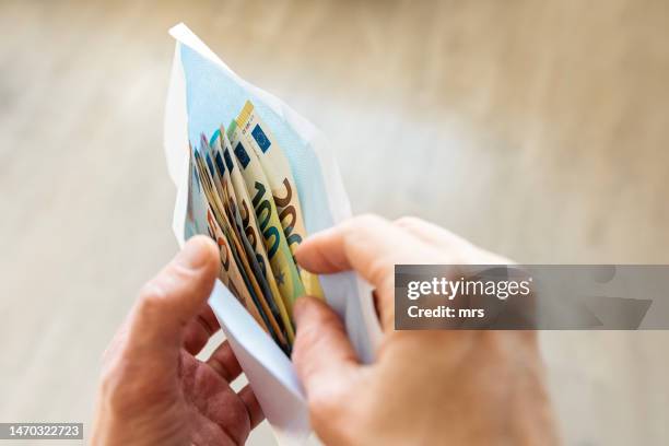 euro banknotes in an envelope - envelope stockfoto's en -beelden