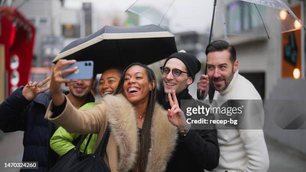 multi-racial group of tourist friends taking selfies and videos while exploring the city in harajuku tokyo - the weekend in news around the world bildbanksfoton och bilder