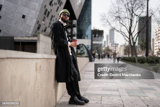 carefree calm black man near modern building with cup of coffee good morning free from work and duty - free guy 個照片及圖片檔