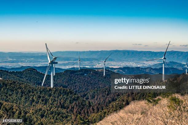 hilltop with wind turbines in winter - wind farms stockfoto's en -beelden