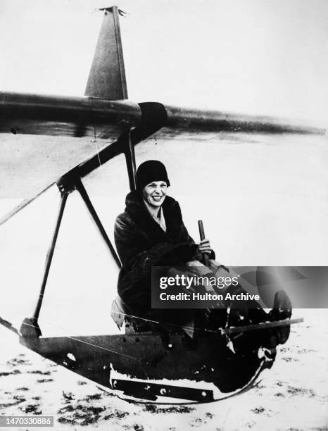 American aviator Amelia Earhart at the controls of an experimental ice-glider at Wildwood Farm, Lake Orion, Michigan, February 1929. Earhart was the...