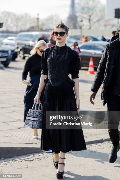 Actress Alexandra Daddario wears black skirt, top, bag outside Dior during Paris Fashion Week - Womenswear Fall Winter 2023 2024 : Day Two on...