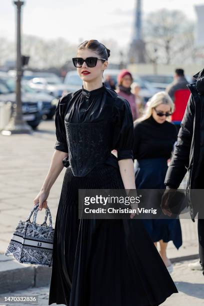 Actress Alexandra Daddario wears black skirt, top, bag outside Dior during Paris Fashion Week - Womenswear Fall Winter 2023 2024 : Day Two on...