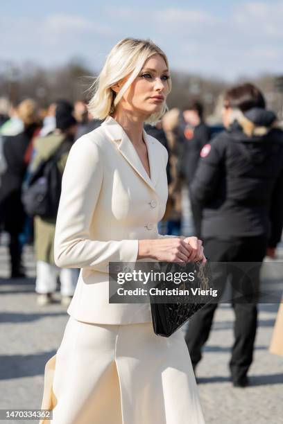 Elsa Hosk wears black bag, creme white blazer, skirt with slits outside Dior during Paris Fashion Week - Womenswear Fall Winter 2023 2024 : Day Two...