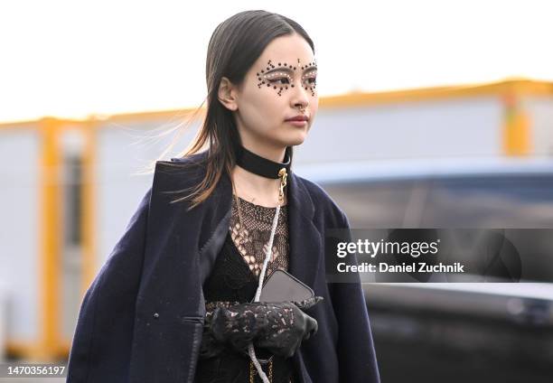 Guest is seen wearing a black jacket, black sheer top with face beaded jewellery outside the Dior show during Paris Fashion Week F/W 2023 on February...